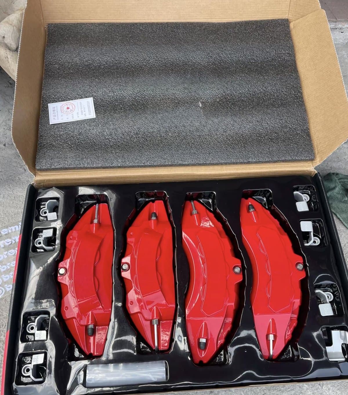 Custom red decorative brake caliper covers with branded packaging