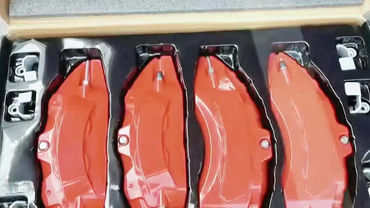 Finished red decorative brake caliper covers arranged in packaging