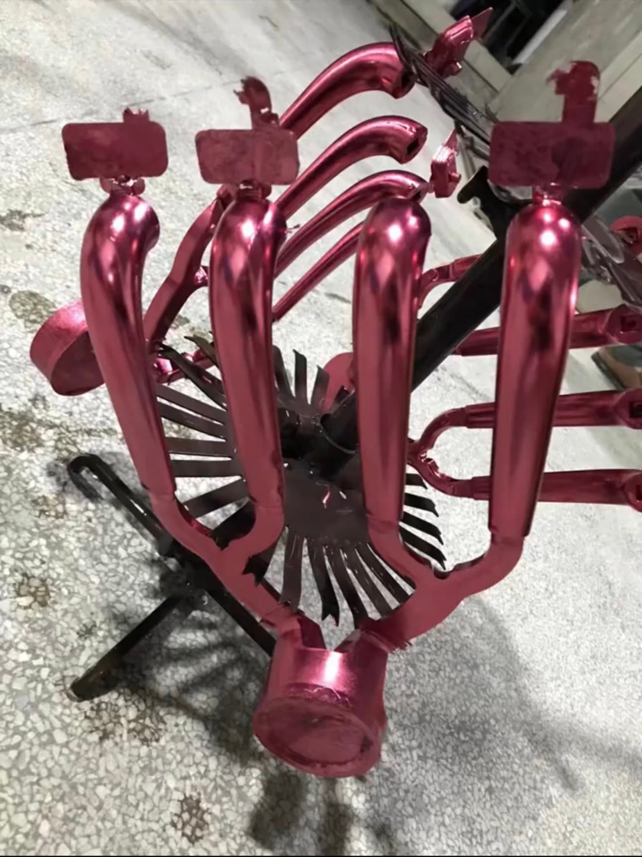 Red anodized die-cast full-shot demonstration sample with gates and overflows attached