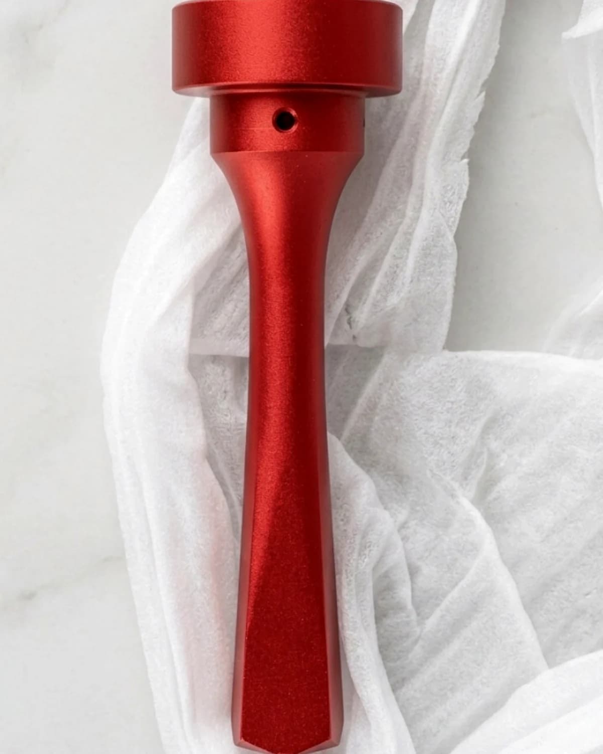 Red anodized aluminum die casting sample after surface preparation
