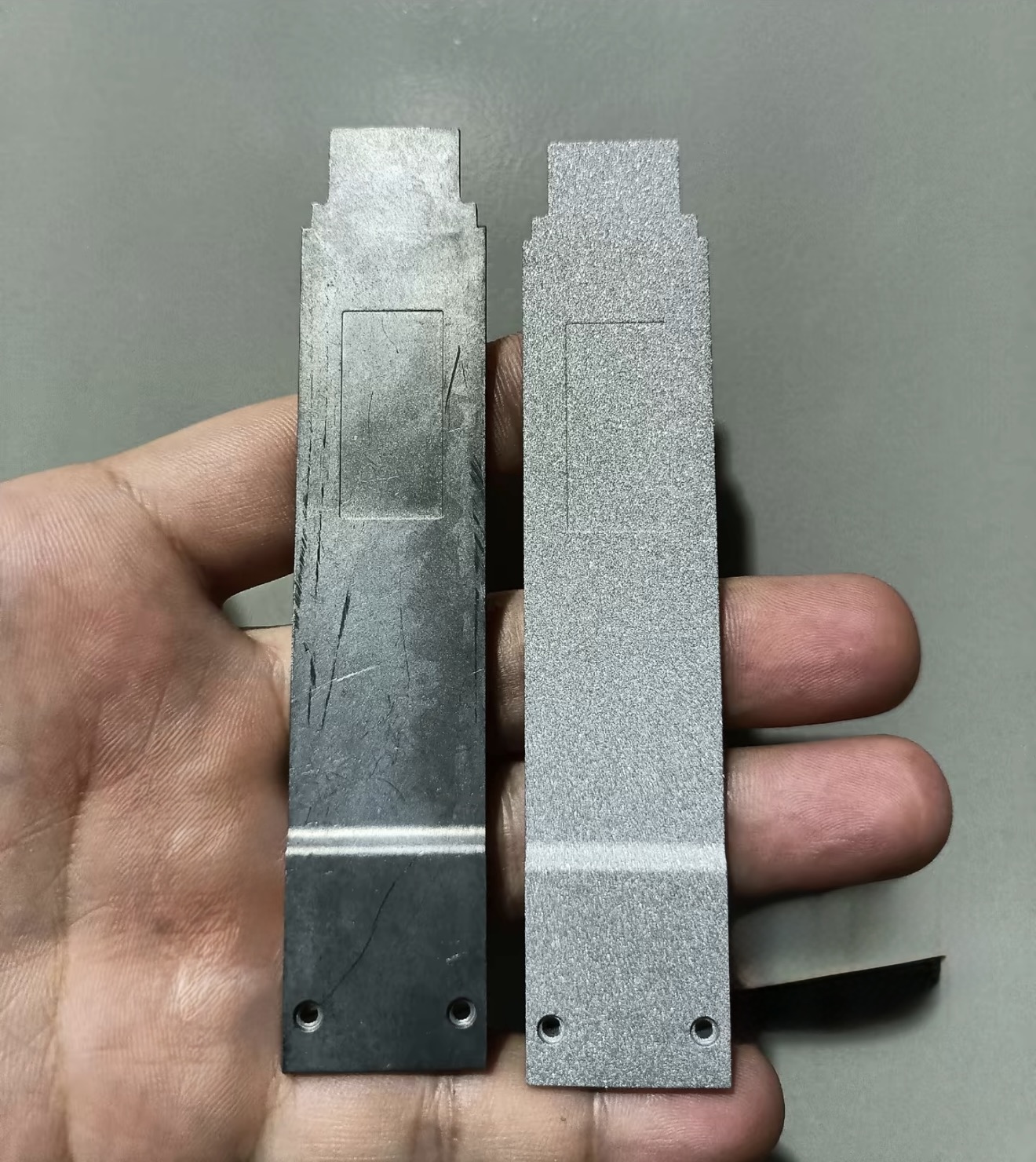 Aluminum die cast samples before and after sandblasting, showing the change from a smoother surface to a uniformly roughened matte finish.