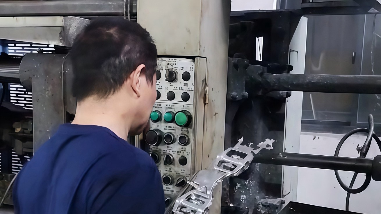 HSX die casting operator monitoring casting ejection and machine conditions during aluminum die casting production.
