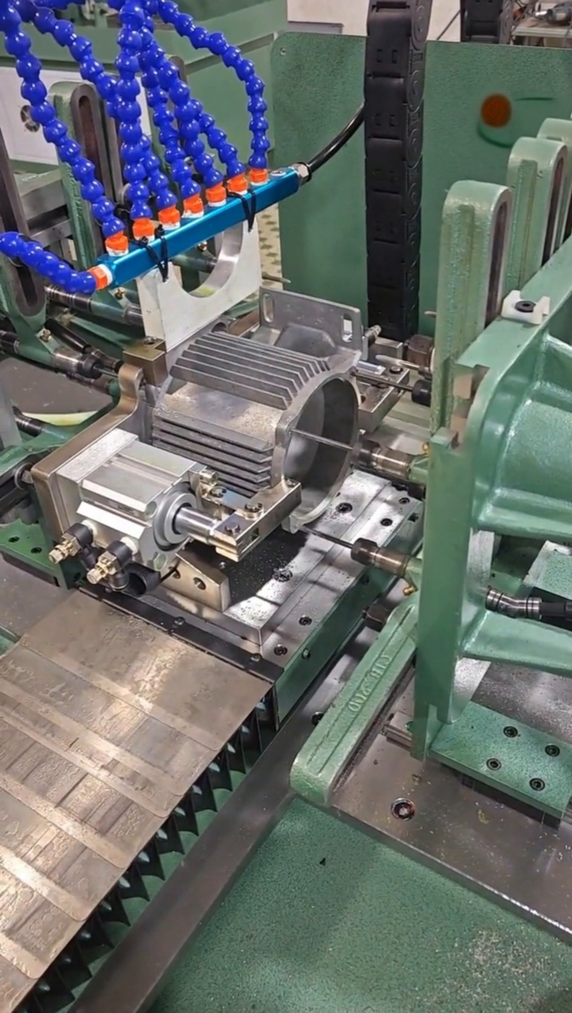 Machining reference showing an aluminum housing clamped in a fixture for secondary machining, illustrating the added setup, tooling and machine time behind machined features.