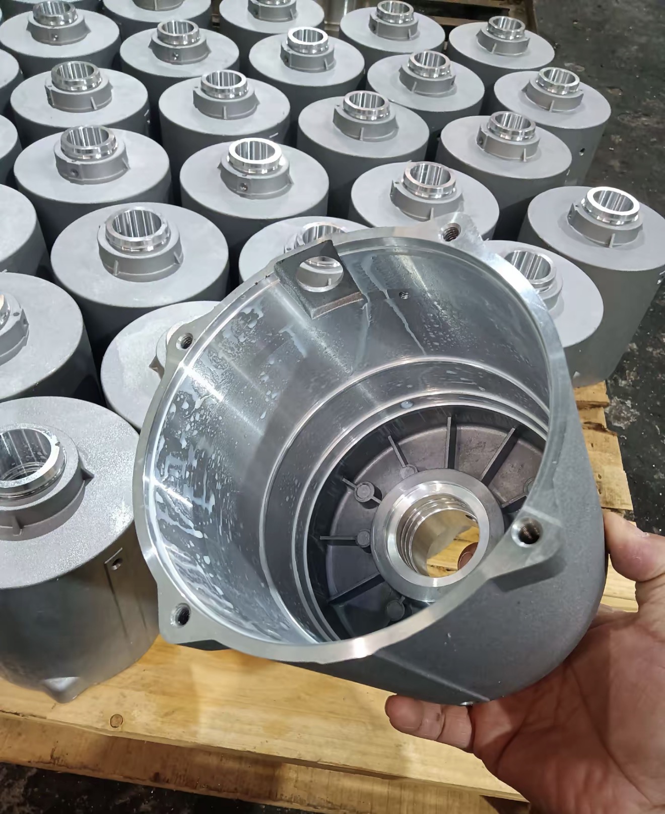 Batch of aluminum housings and one housing showing the internal cavity bore and machined mating surfaces