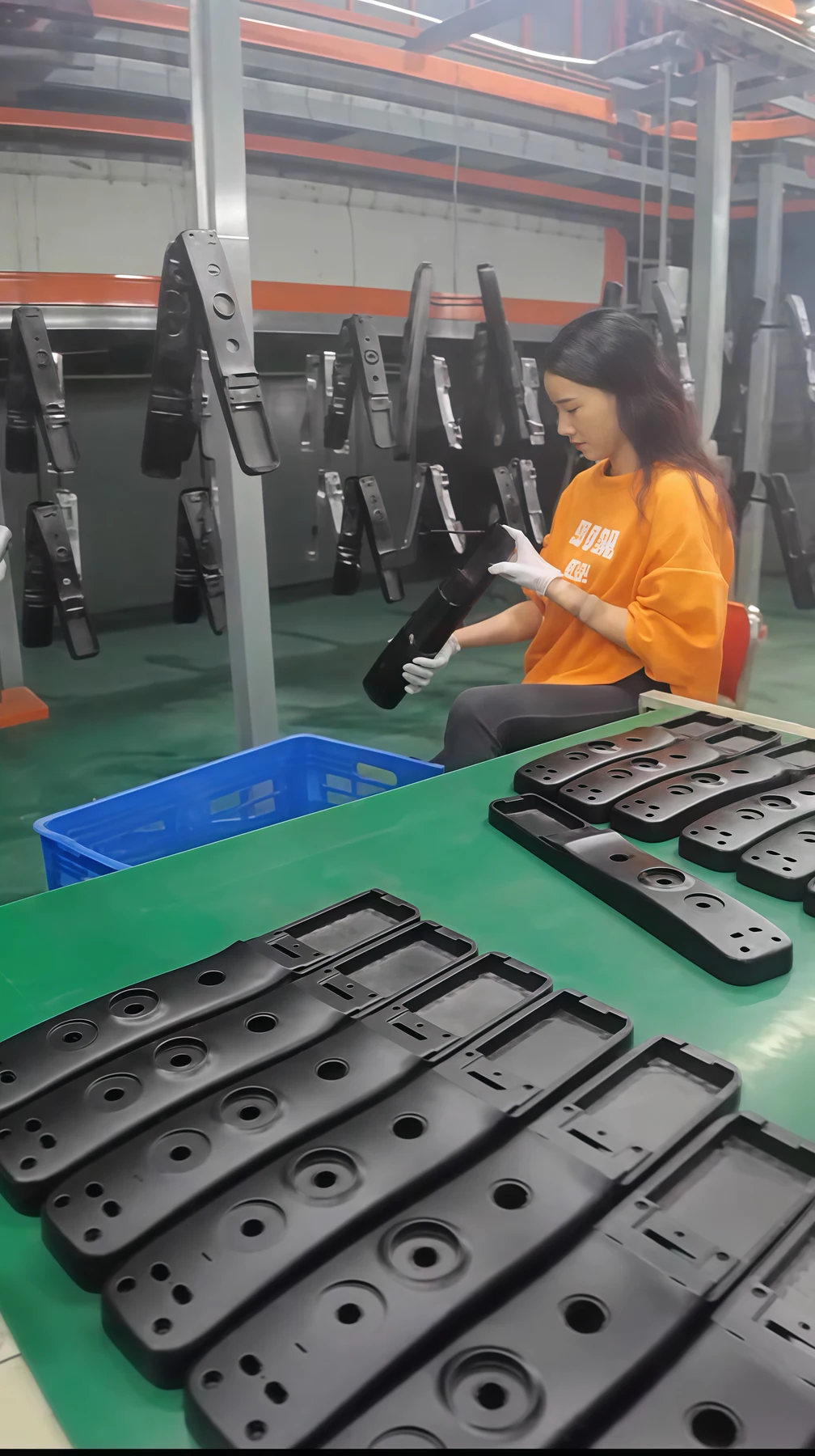 Worker visually inspecting coated fingerprint lock panels