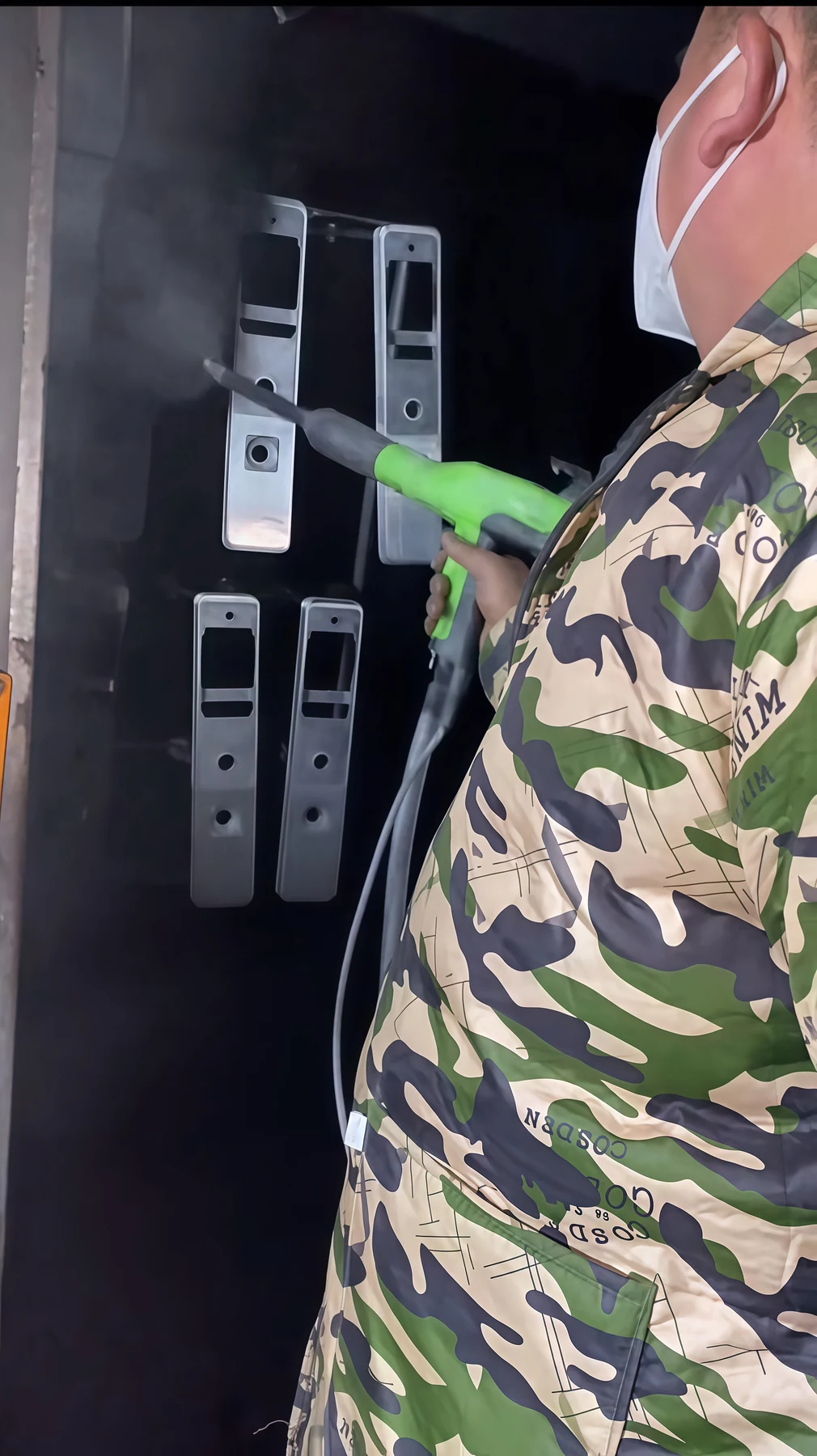 Spray coating the fingerprint lock panel aluminum component at HSX