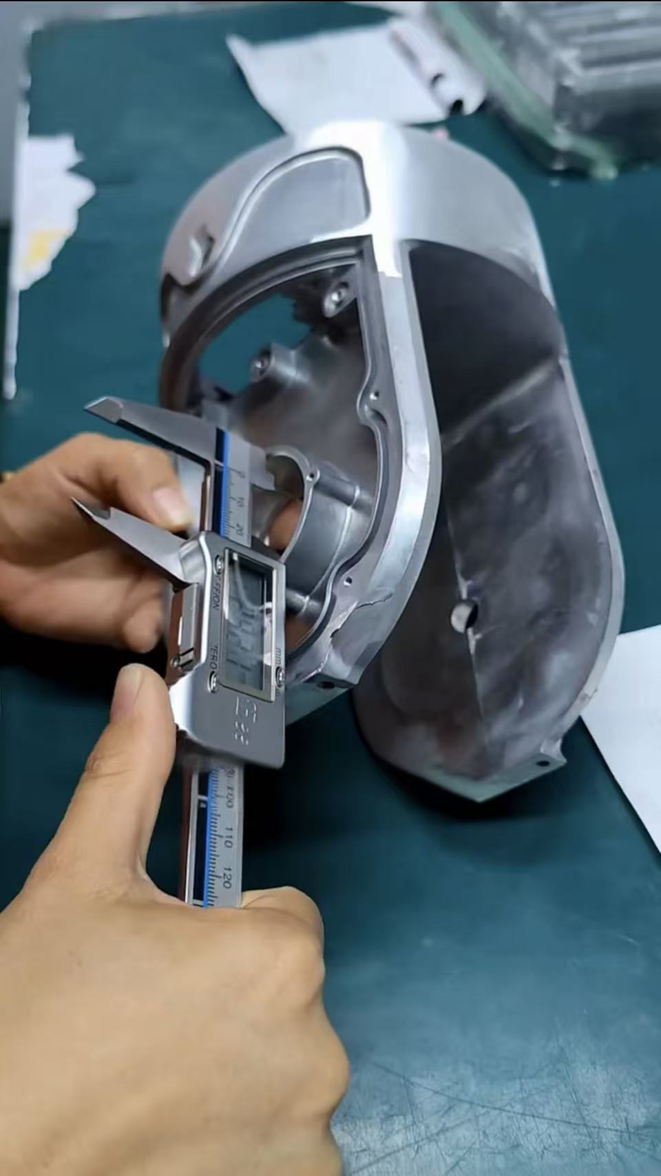 Digital caliper checking a feature on a custom aluminum casting.